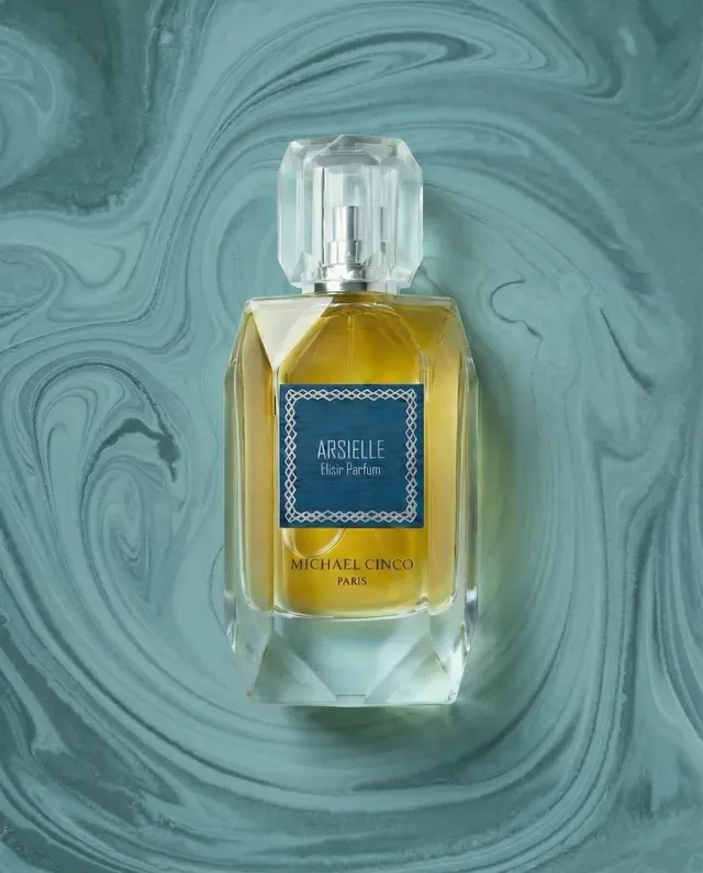 Arsielle elixir parfum on a teal studio field