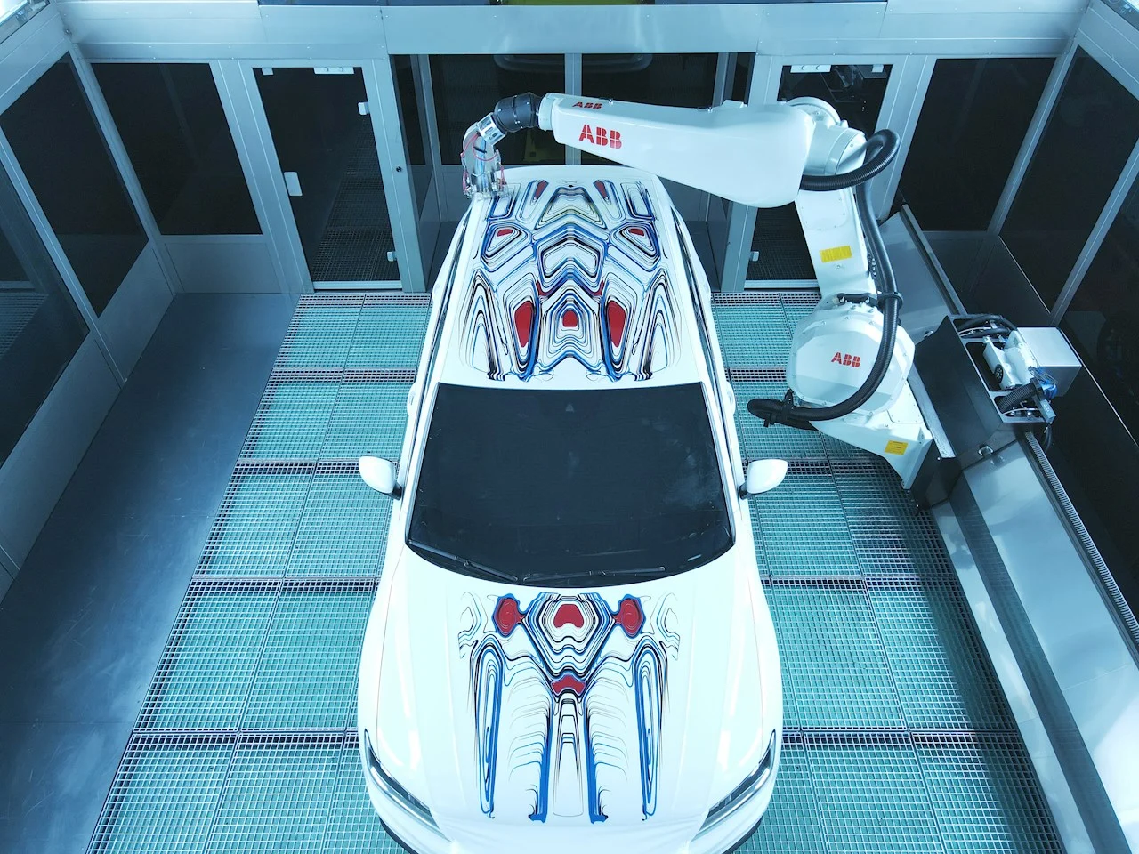 The art car in the paint booth with the ABB robot alongside