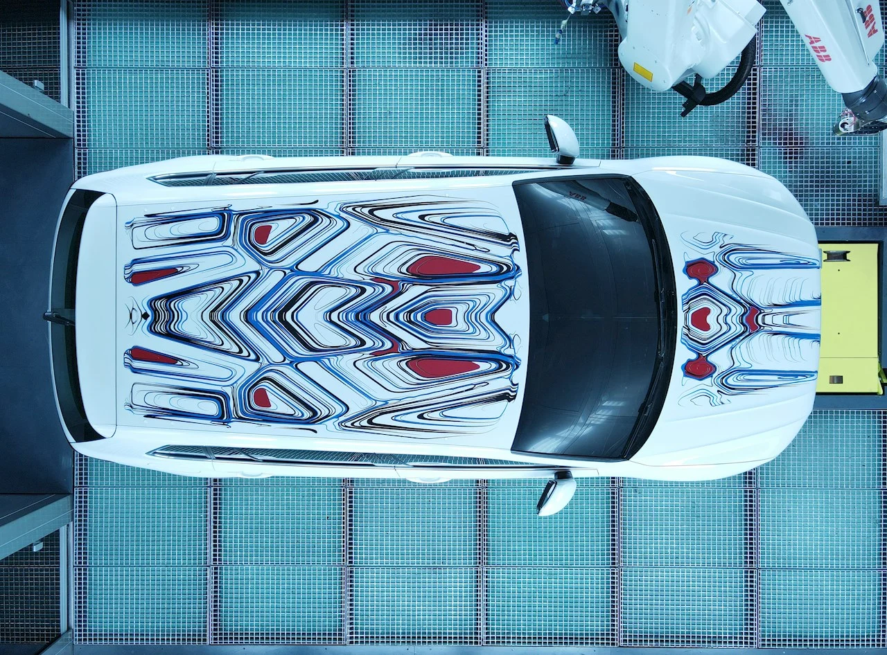 The finished art car seen top-down, artwork across roof and bonnet