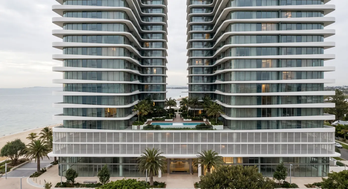Twin residential towers above the pool courtyard
