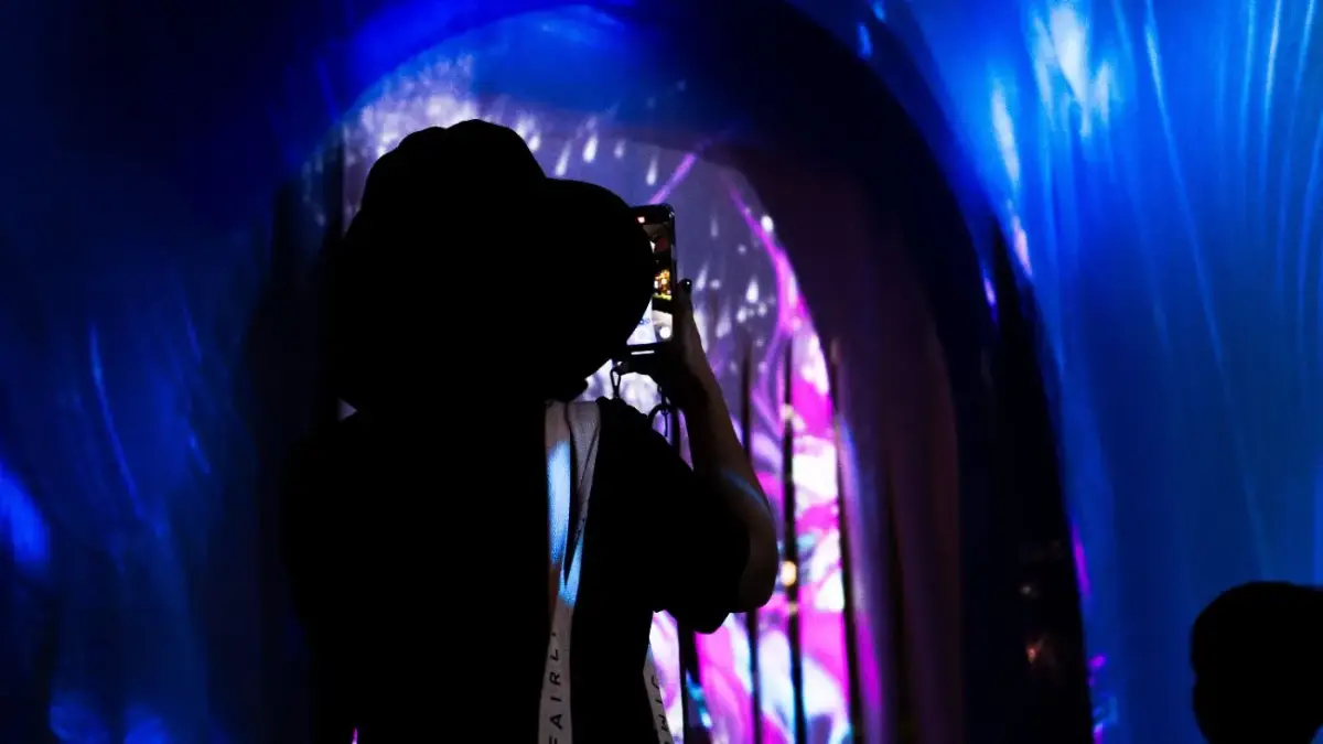 A visitor photographing the reflective surfaces